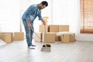 Man cleaning floor during move-in