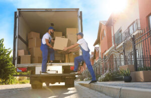 Movers loading boxes into a truck.