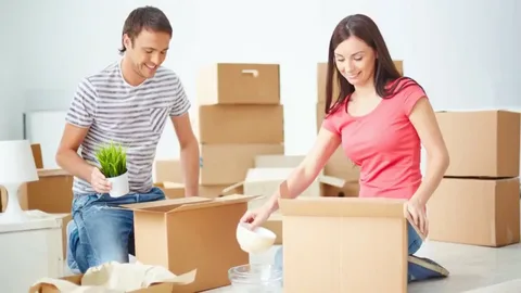 Couple packing boxes at home