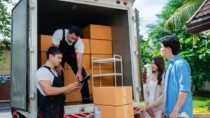 Professional movers loading packed boxes into a moving truck